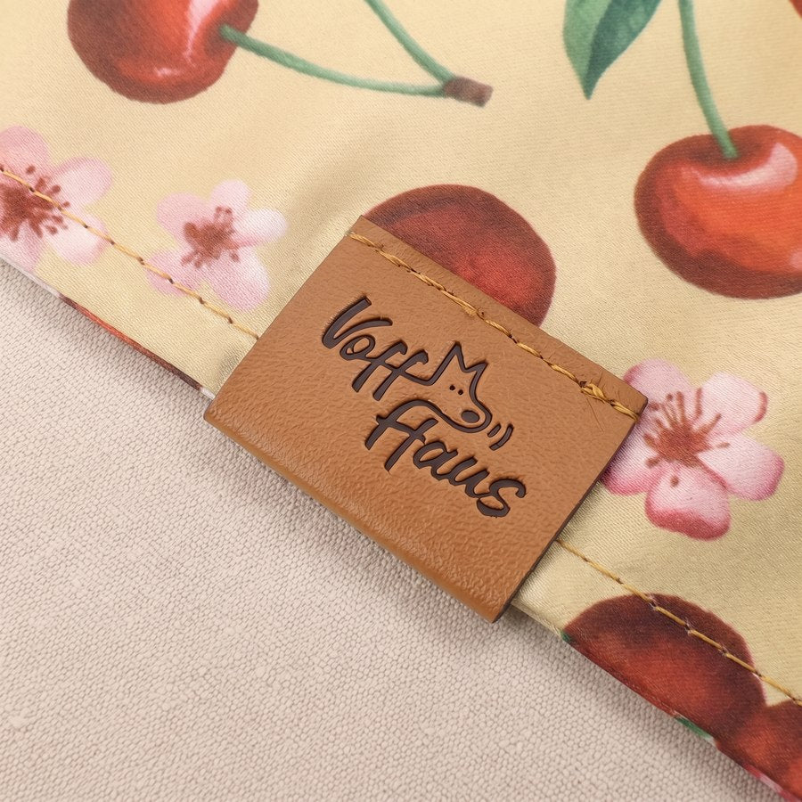 The stitched Voff Haus leather tag on a Cherry Pop bandana