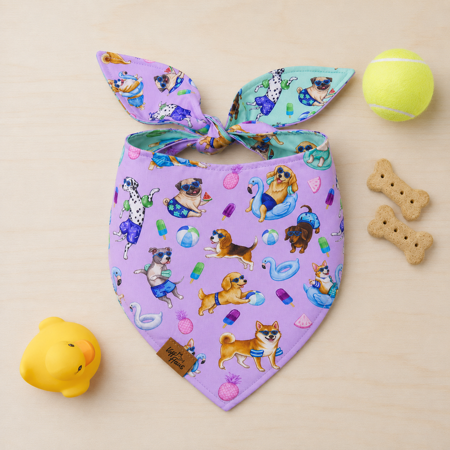 The Endless Pawty reversible dog bandana tied flat, lavender side with pups riding pool floats
