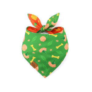 Green dog bandana with floral and bone pattern on a white background