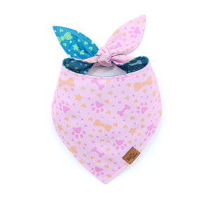 Pink bandana with colorful patterns and bunny ears on a white background