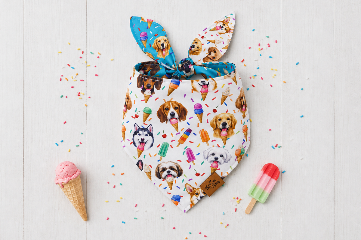 Scoops & Snoots reversible dog bandana, ivory side with dog faces, cones and sprinkles